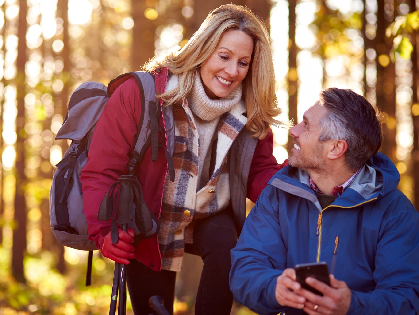 Private equity partner discussing a carry distribution plan with reserves, taxes, giving, and goals with her husband in the woods.