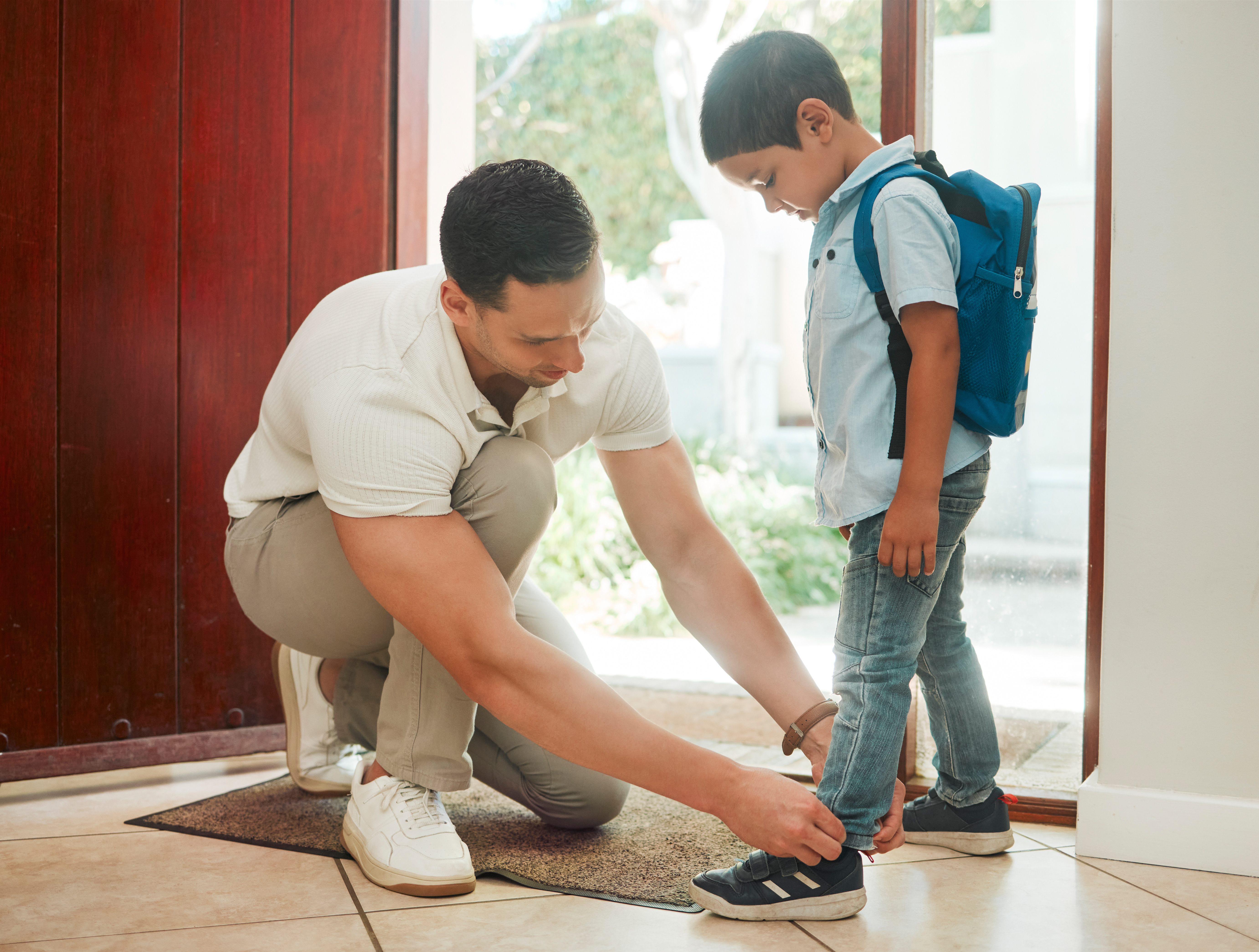 A father helps his son tie his shoe and considers estate planning and children.
