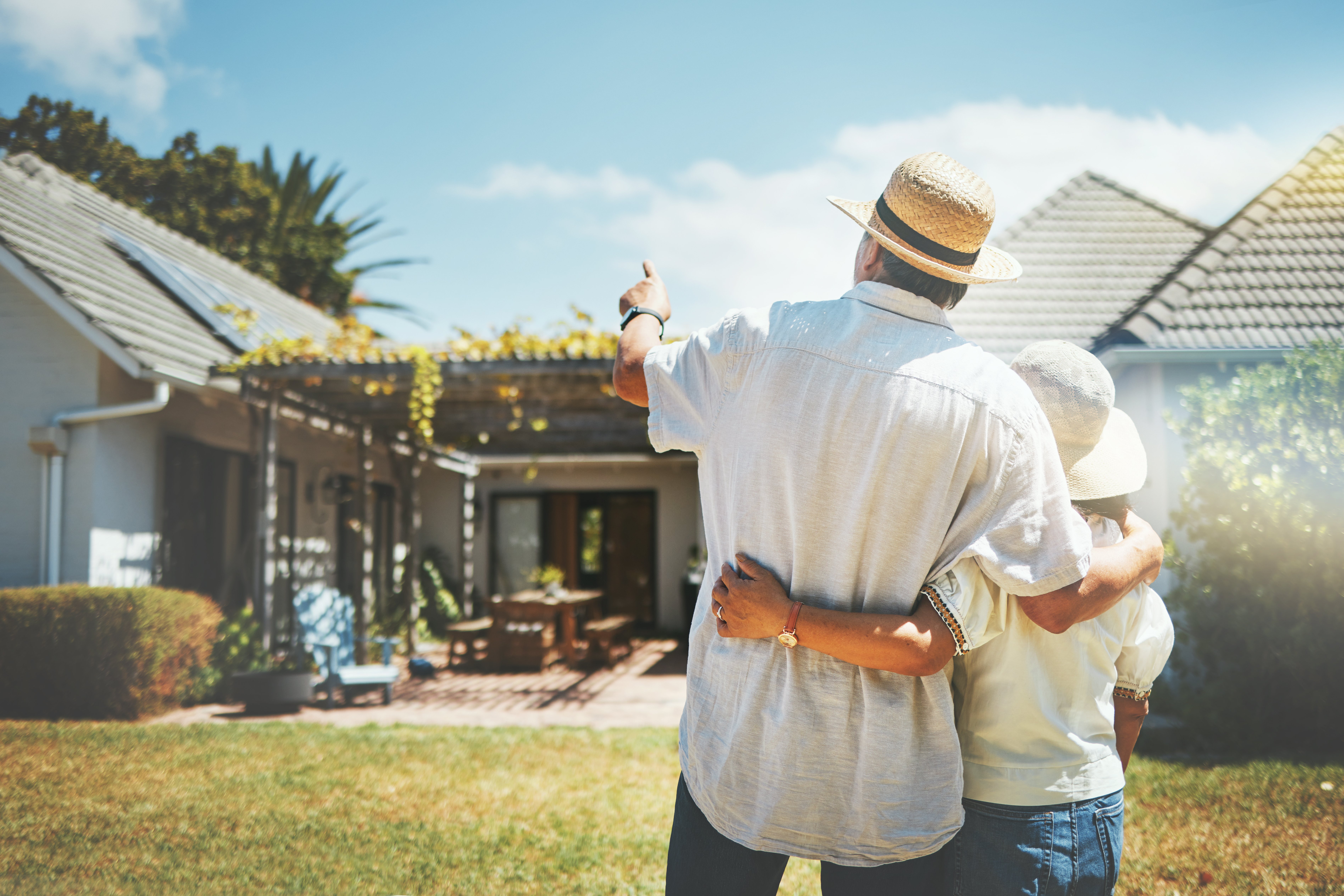 couple outside of home discussing if reverse mortgage is right for them