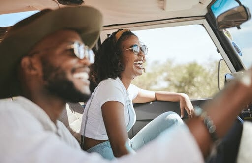 Young couple on a road trip. Couples at every stage can benefit from financial planning.