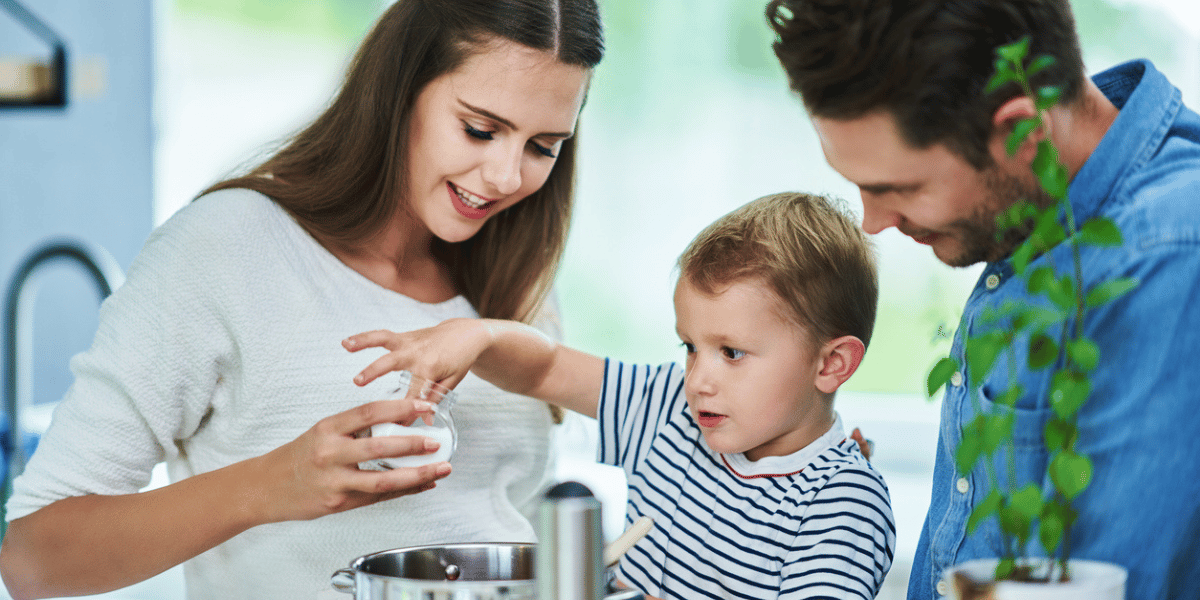 young family cooking in the kitchen, they have peace of mind their financial planning is taken care of at Sachetta