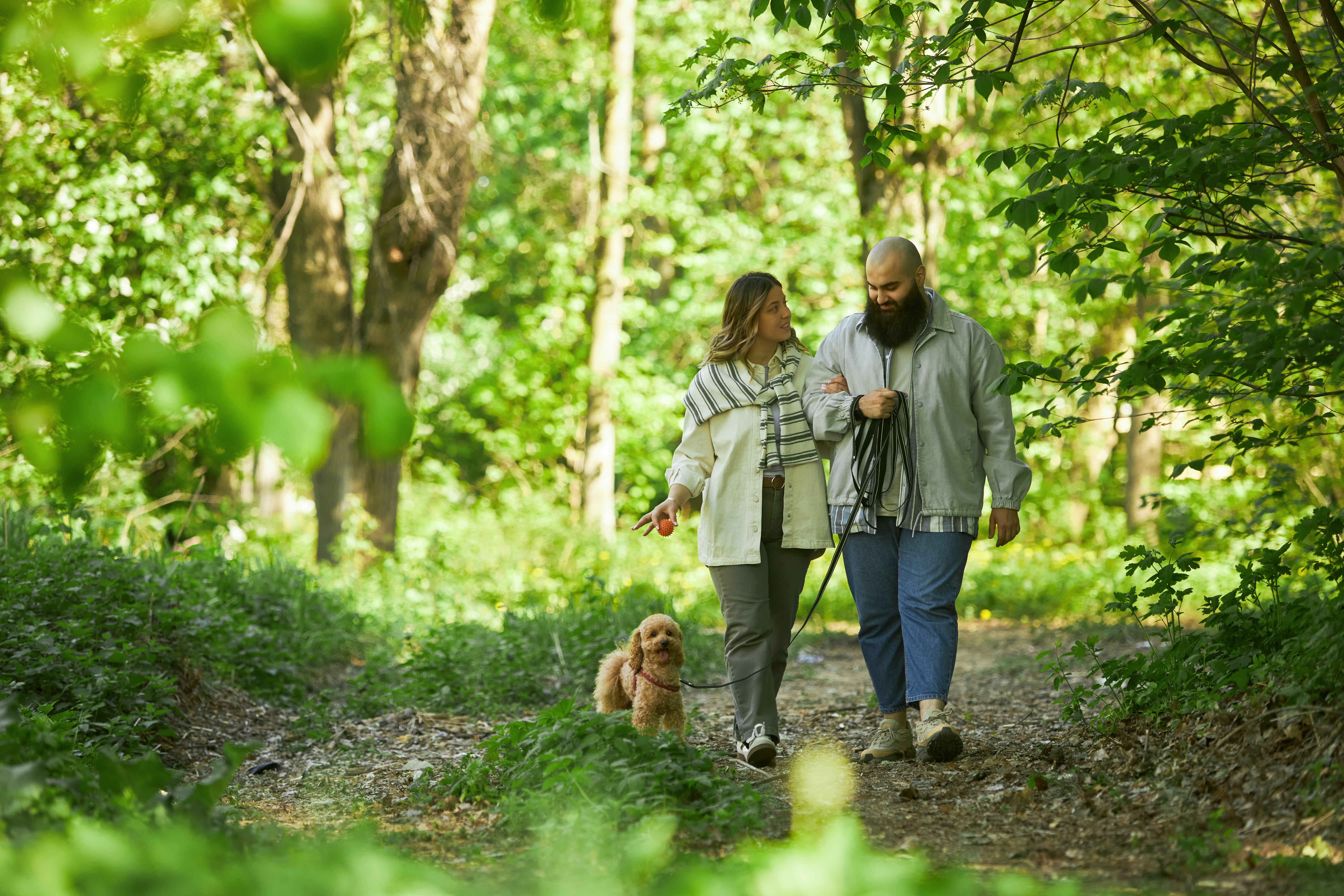 Couple walks through woods discussing how to manage their sudden wealth 