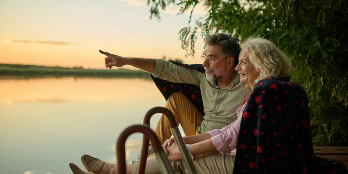 couple over 65 enjoying retirement outside on lake happy they chose the Medigap plan 