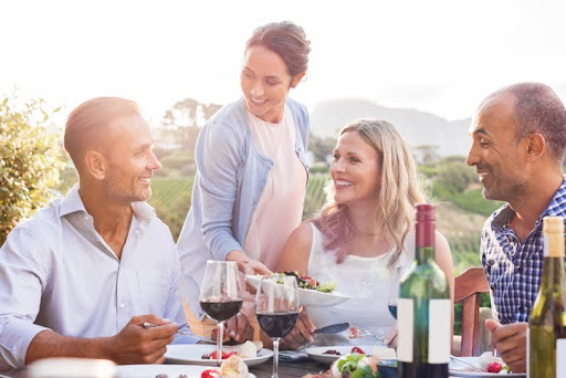 Happy mature friends having dinner together. Tax-efficient investing is about growing investments in ways that are aligned with your broader financial goals—without losing more to taxes than you need to. 