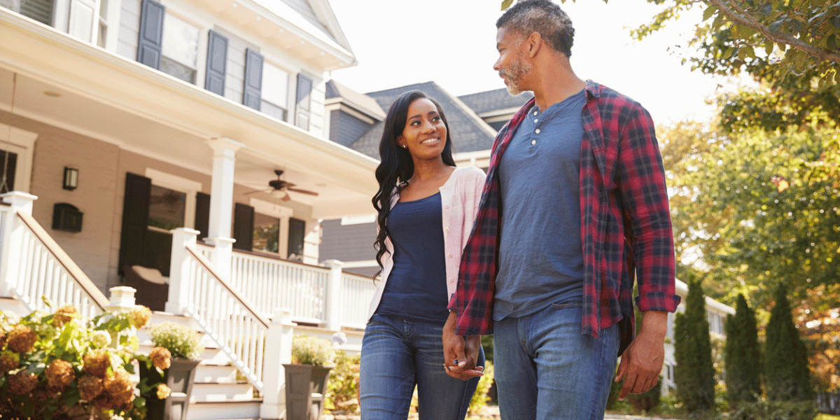 couple on a walk holding hands having a conversation about their investment property tax deductions